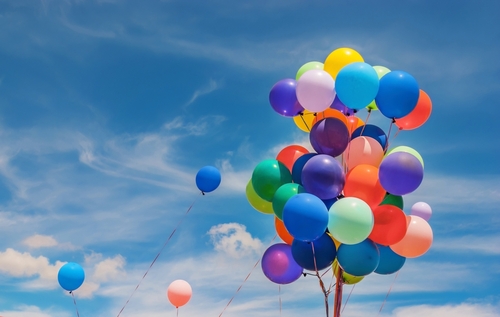 A,Group,Of,Colorful,Balloons,Outside,On,A,Cloudy,Day